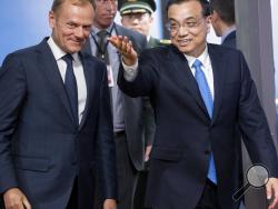  Chinese Premier Li Keqiang, right, gestures as he walks with European Council President Donald Tusk prior to a meeting at the Europa building in Brussels on Thursday, June 1, 2017. (Olivier Hoslet, Pool Photo via AP)