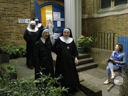  Benedictine nuns from Tyburn Convent leave after voting in Britain's general election at a polling station in St John's Parish Hall, London, Thursday, June 8, 2017. Polls are open from 7 a.m. to 10 p.m. (0600GMT to 2100GMT) Thursday as voters choose 650 lawmakers for the House of Commons. Prime Minister Theresa May called the snap election in hopes of increasing the Conservative Party's slim majority in Parliament, and strengthening her hand in European Union exit talks. (AP Photo/Matt Dunham)