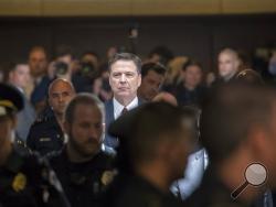 Former FBI director James Comey walks through a corridor on the way to a secure room to continue his testimony to the Senate Select Committee on Intelligence, on Capitol Hill in Washington, Thursday, June 8, 2017. (AP Photo/J. Scott Applewhite)