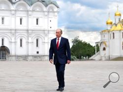 Russian President Vladimir Putin walks along the Cathedral Square of the Kremlin, to take part in a holiday reception in Moscow, Monday, June 12, 2017. Since 1992 the 'Day of Russia' is annually celebrated on 12 June as the Russian Federation's national holiday.(Alexei Druzhinin/Sputnik, Kremlin Pool Photo via AP)