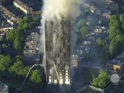  In this photo taken from aerial video, smoke rises from a high-rise apartment building on fire in London, Wednesday, June 14, 2017. A massive fire raced through the 27-story high-rise apartment building in west London early Wednesday, sending at least 30 people to hospitals, emergency officials said. (Sky News via AP)