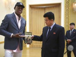  Former NBA basketball star Dennis Rodman presents a book titled "Trump The Art of the Deal" to North Korea's Sports Minister Kim Il Guk Thursday, June 15, 2017, in Pyongyang, North Korea. (AP Photo/Kim Kwang Hyon)
