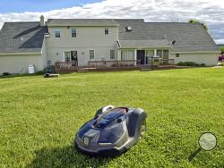  ADVANCE FOR SATURDAY, JUNE 24, 2017 -In this Wednesday, June 7, 2017 photo, a robotic mower is pictured in the yard of Dave Dagen in Lititz, Pa. (Dan Marschka/LNP via AP)