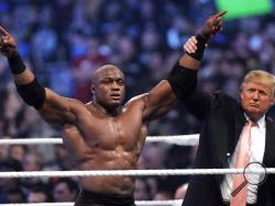  FILE - In this Sunday, April 1, 2007, file photo, Donald Trump raises the arm of wrestler Bobby Lashley after he defeated Umaga at Wrestlemania 23 at Ford Field in Detroit. Trump body-slammed and then shaved the head of WWE boss Vince McMahon after what was known as the “Battle of the Billionaires." Wrestling aficionados say the president has, consciously or not, long borrowed the time-tested tactics of the game to cultivate the ultimate antihero character, a figure who wins at all costs, incites outrage 