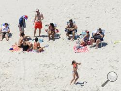  In this Sunday, July 2, 2017, photo, New Jersey Gov. Chris Christie, right, uses the beach with his family and friends at the governor's summer house at Island Beach State Park in New Jersey. Christie is defending his use of the beach, closed to the public during New Jersey's government shutdown, saying he had previously announced his vacation plans and the media had simply "caught a politician keeping his word." (Andrew Mills/NJ Advance Media via AP)