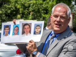  Bucks County District Attorney Matthew Weintraub holds up photos of four men who are missing during a news conference in Solebury Township, Pa., Monday, July 10, 2017. The four men, who went missing last week, are Dean Finocchiaro, from left, Tom Meo, Jimi Tar Patrick and Mark Sturgis. (Clem Murray/The Philadelphia Inquirer via AP)