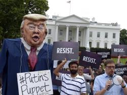  People gather outside the White House on Pennsylvania Avenue in Washington, Tuesday, July 11, 2017, to protest President Donald Trump. (AP Photo/Susan Walsh)