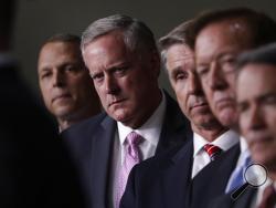  House Freedom Caucus Chairman Rep. Mark Meadows, R-N.C., second from left, and others, participates in a news conference on Capitol Hill in Washington, Wednesday, July 12, 2017, to say that his group wants to delay the traditional August recess until work is accomplished on health care, the debt ceiling and tax reform. (AP Photo/J. Scott Applewhite)