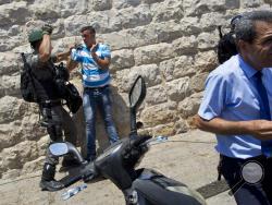 Israeli police officers clash with Palestinians outside the Lion's Gate, following an appeal from clerics to pray in the streets instead of the Al Aqsa Mosque compound, in Jerusalem's Old City, Wednesday, July 19, 2017. A dispute over metal detectors has escalated into a new showdown between Israel and the Muslim world over the contested Jerusalem shrine that has been at the center of violent confrontations in the past. (AP Photo/Oded Balilty)