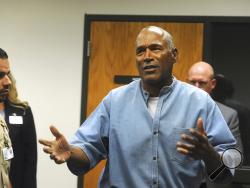Former NFL football star O.J. Simpson reacts after learning he was granted parole at the Lovelock Correctional Center in Lovelock, Nev., on Thursday, July 20, 2017. Simpson was granted parole Thursday after more than eight years in prison for a Las Vegas hotel heist, successfully making his case in a nationally televised hearing that reflected America's enduring fascination with the former football star. (Jason Bean/The Reno Gazette-Journal via AP, Pool)