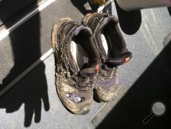 In this photo provide by the Bryan, Texas Fire Department, taken on April 29, 2014, shoes belonging to one of the three workers injured after an explosion at the Bryan Texas Utilities Power Plant. The fire killed a 60-year-old worker and injured another two workers. Older people are dying on the job at a higher rate than workers overall, even as the rate of workplace fatalities decreases, according to an Associated Press analysis of federal statistics. (Bryan, Texas Fire Department via AP)