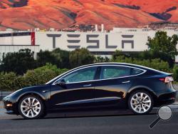 This undated image provided by Tesla Motors shows the Tesla Model 3 sedan. The electric car company’s newest vehicle, the Model 3, which set to go to its first 30 customers Friday, July 28, 2017, is half the cost of previous models. Its $35,000 starting price and 215-mile range could bring hundreds of thousands of customers into Tesla’s fold, taking it from a niche luxury brand to the mainstream. (Courtesy of Tesla Motors via AP)