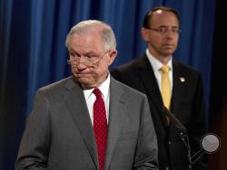 Deputy Attorney General Rod Rosenstein watches at right as Attorney General Jeff Sessions steps away from the podium during a news conference at the Justice Department in Washington, Friday, Aug. 4, 2017, on leaks of classified material threatening national security. (AP Andrew Harnik)