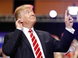 President Donald Trump reacts to the song as he arrives at a rally at the Phoenix Convention Center, Tuesday, Aug. 22, 2017, in Phoenix. (AP Photo/Alex Brandon)