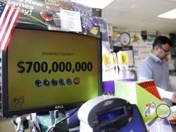 A Powerball lottery sign displays the lottery prizes at a convenience store Wednesday, Aug. 23, 2017, in Northbrook, Ill. Lottery officials said the grand prize for Wednesday night's drawing has reached $700 million, the second -largest on record for any U.S. lottery game. (AP Photo/Nam Y. Huh)