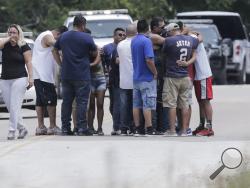 Family members react as a van is pulled out of the Greens Bayou with the bodies of several family members on Wednesday, Aug. 30, 2017, in Houston. The van was carried into the bayou during Tropical Storm Harvey as the water went over the bridge. (Elizabeth Conley/Houston Chronicle via AP)