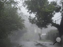 High winds and rain sweep through the streets of the Matelnillo community during the passage of hurricane Irma, in Fajardo, Puerto Rico, Wednesday, Sept. 6, 2017. The US territory was first to declare a state of emergency las Monday, as the National Hurricane Center forecast that the storm would strike the Island Wednesday. (AP Photo/Carlos Giusti)