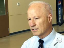 FILE - In this Aug. 1, 2017, file photo, Colorado Republican Rep. Mike Coffman speaks to reporters before holding a constituent town hall in Brighton, Colo. (AP Photo/Jim Anderson, File)