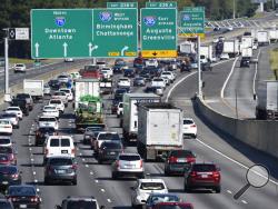 Heavy traffic traveling north bound on Interstate 75 moves slowly, as a major evacuation has begun in preparation for Hurricane Irma, Friday, Sept. 8, 2017, in Forrest Park, south of Atlanta. (AP Photo/Mike Stewart)