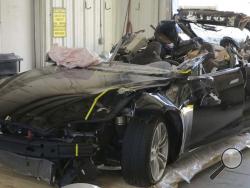 This image provided by the National Transportation Safety Board shows the damage to the left front of the Tesla involved in a May 7, 2016, crash in Williston, Fla. Investigators are meeting Sept. 12, 2017, to determine the likely cause of the crash that killed Joshua Brown, 40, of Canton, Ohio, who was using the semiautonomous driving systems of his Tesla Model S sedan. The sedan struck the underside of a semitrailer that was turning onto a divided highway in Williston. The sedan's roof was sheared off befo