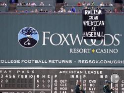 A banner is unfurled over the left field wall during the fourth inning of a baseball game between the Boston Red Sox and the Oakland Athletics at Fenway Park in Boston, Wednesday, Sept. 13, 2017. (AP Photo/Charles Krupa)