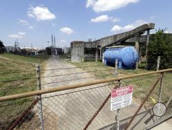 A gate at the U.S. Oil Recovery Superfund site is shown Thursday, Sept. 14, 2017, in Pasadena, Texas, where three tanks once used to store toxic waste were flooded during Hurricane Harvey. The Environmental Protection Agency says it has found no evidence that toxins washed off the site, but is still assessing damage. (AP Photo)