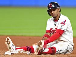 Cleveland Indians' Francisco Lindor sits near second base after being forced out in a double play in the seventh inning of a baseball game against the Kansas City Royals, Friday, Sept. 15, 2017, in Cleveland. (AP Photo/David Dermer)