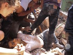 A man is rescued from a collapsed building in the Condesa neighborhood of Mexico City after an earthquake in Mexico, Tuesday, Sept. 19, 2017. The 7.1 earthquake stunned central Mexico, killing more than 100 people. (AP Photo/Pablo Ramos)