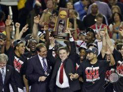 FILE - In this April 8, 2013, file photo, Louisville players and head coach Rick Pitino celebrate after defeating Michigan 82-76 in the championship of the Final Four in the NCAA college basketball tournament in Atlanta. Louisville announced Wednesday, Sept. 27, 2017, that they have placed basketball coach Rick Pitino and athletic director Tom Jurich on administrative leave amid an FBI probe. (AP Photo/Chris O'Meara, File)