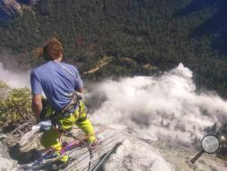 In this photo provided by Peter Zabrok, climber Ryan Sheridan who had just reached the top of El Capitan, a 7,569-foot (2,307 meter) formation, when a rock slide let loose below him Thursday, Sept. 28, 2017, in Yosemite National Park, Calif. It was not immediately clear if there were new casualties, a day after another slab dropped from El Capitan, killing a British climber and injuring a second. (Peter Zabrok via AP)