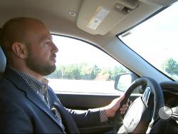 In this image from video, Jake Nelson, AAA’s director for traffic safety advocacy and research drives one of the test vehicles used in the study in Washington, Wednesday, Oct. 4, 2017. Infotainment technology automakers are cramming into the dashboard of new vehicles is making drivers take their eyes off the road and hands off the wheel for dangerously long periods of time, a study being released by AAA on Oct. 5 says. (AP Photo/Bill Gorman)