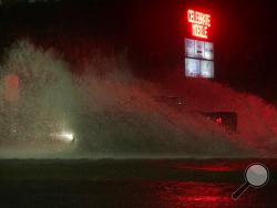 A large truck drives through a flooded Water St. in downtown Mobile, Ala., during Hurricane Nate, Sunday, Oct. 8, 2017, in Mobile, Ala. Hurricane Nate came ashore along Mississippi's coast outside Biloxi early Sunday, the first hurricane to make landfall in the state since Hurricane Katrina in 2005. (AP Photo/Brynn Anderson)