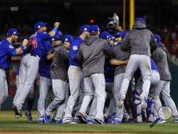 The Chicago Cubs celebrate after beating the Washington Nationals 9-8 to to win baseball's National League Division Series, at Nationals Park, early Friday, Oct. 13, 2017, in Washington. (AP Photo/Pablo Martinez Monsivais)