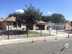 The house used in the AMC-TV series "Breaking Bad" with poles for a new fence is shown in this Friday, Oct. 13, 2017 photo in Albuquerque, N.M. The owners are erecting the fence around the real Albuquerque house made famous by the methamphetamine-making character Walter White, because the property has been plagued by countless fans wanting snapshots and selfies. (AP Photo/Russell Contreras)