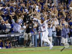 Los Angeles Dodgers' Justin Turner celebrates after a three-run walk off home run against the Chicago Cubs during the ninth inning of Game 2 of baseball's National League Championship Series in Los Angeles, Sunday, Oct. 15, 2017. The Dodgers won, 4-1. (AP Photo/Alex Gallardo)