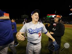 Los Angeles Dodgers' Enrique Hernandez celebrates with his teammates celebrate after Game 5 of baseball's National League Championship Series against the Chicago Cubs, Thursday, Oct. 19, 2017, in Chicago. The Dodgers won 11-1 to win the series and advance to the World Series. (AP Photo/Matt Slocum)
