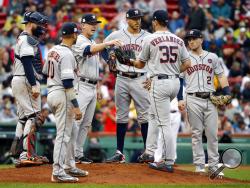 FILE - In this Oct. 9, 2017, file photo, Houston Astros manager A.J. Hinch, third from left, gives the ball to pitcher Justin Verlander (35) for his very first Major League relief appearance during the fifth inning in Game 4 of baseball's American League Division Series against the Boston Red Sox, in Boston. No need for catchers to worry about getting they're running in, especially during the postseason. They are taking so many trips to the mound for discussions, the average time of a nine-inning game is 3 