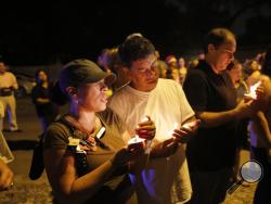 During a candlelight vigil Jacqueline Melendez, left, and her husband Jose Melendez mourn the death of three victims who were killed in the recent shootings in the Seminole Heights neighborhood in Tampa on Sunday, October 22, 2017. The deaths, which took place in the same neighborhood over the past 10 days, prompted Tampa police to warn residents in the Seminole Heights neighborhood not to walk alone at night.(Octavio Jones/The Tampa Bay Times via AP)