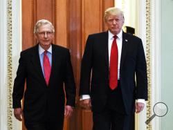 President Donald Trump, escorted by Senate Majority Leader Mitch McConnell, R-Ky., arrives on Capitol Hill to have lunch with Senate Republicans and push for his tax reform agenda, in Washington, Tuesday, Oct. 24, 2017. (AP Photo/Manuel Balce Ceneta)