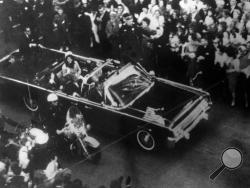 This image provided by the Warren Commission is an overhead view of President John F. Kennedy's car in Dallas motorcade on Nov. 22, 1963, and was the commission's Exhibit No. 698. Special agent Clinton J. Hill is shown riding atop the rear of the limousine. President Donald Trump is caught in a push-pull on new details of Kennedy’s assassination, jammed between students of the killing who want every scrap of information and intelligence agencies that are said to be counseling restraint. How that plays out s