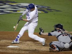 Los Angeles Dodgers' Joc Pederson hits a home run against the Houston Astros during the seventh inning of Game 6 of baseball's World Series Tuesday, Oct. 31, 2017, in Los Angeles. (AP Photo/Jae C. Hong)