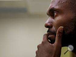 In this Tuesday, Oct. 24, photo, addiction counselor DeValle Williams listens to a conversation on opioid addiction at the nurses station at Saint Anthony Hospital in Chicago. Long before President Donald Trump declared the opioid crisis a national public health emergency, Williams and his team were fighting in the trenches where it's tough to tell victory from defeat on any given day. (AP Photo/Charles Rex Arbogast)