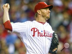 FILE - In this Oct. 6, 2010 file photo, Philadelphia Phillies pitcher Roy Halladay, throws against the Cincinnati Reds during Game 1 of baseball's National League Division Series, in Philadelphia. Roy Halladay, a two-time Cy Young Award winner who pitched a perfect game and a playoff no-hitter, died Tuesday when his private plane crashed into the Gulf of Mexico, Tuesday, Nov. 7, 2017. He was 40. (Jose F. Moreno/Camden Courier-Post via AP, File)