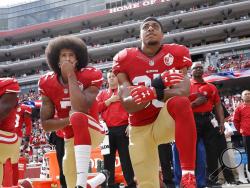 FILE - In this Oct. 2, 2016 file photo, San Francisco quarterback Colin Kaepernick, left, and safety Eric Reid kneel during the national anthem before an NFL football game against the Dallas Cowboys in Santa Clara, Calif. Reid says his Christian faith is the reason why he joined former teammate Colin Kaepernick in kneeling for the anthem. (AP Photo/Marcio Jose Sanchez, File)
