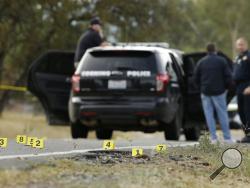 Yellow tags mark where bullet casings found at one of the scenes of a shooting spree at Rancho Tehama Reserve, near Corning, Calif., Tuesday, Nov. 14, 2017. Law enforcement says that five people, including the shooter were killed, and several people including some children were injured during the shooting spree that occurred at multiple locations. (AP Photo/Rich Pedroncelli)