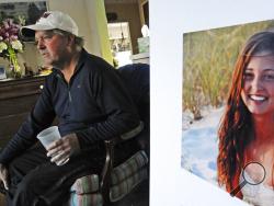 FILE - In this Jan. 23, 2014 file photo, James Holleran, father of Madison Holleran, a University of Pennsylvania freshman who took her own life, talks about his daughter while sitting next to a favorite photo of her at his home in Allendale, N.J. Nearly half of the largest U.S. public universities do not track suicides among their students, despite making investments in prevention at a time of surging demand for mental health services. After her 2014 suicide, one of her former teachers in New Jersey was su