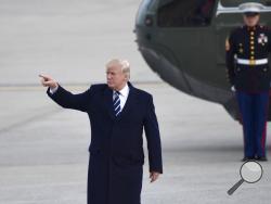 President Donald Trump gestures as he walks towards Air Force One at John F. Kennedy International Airport in New York, Saturday, Dec. 2, 2017. Trump spent the day in New York attending a trio of fundraisers. (AP Photo/Susan Walsh)