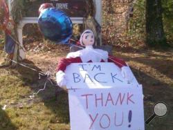 In this photo provided by Cindy McHugh, Zippy, the beloved elf on a shelf for the town of Deerfield, N.H., sits in front of the Deerfield Community School on Wednesday, Dec. 6, 2017. Zippy, who appears throughout the town during the holiday season, was taken on Monday afternoon and mysteriously reappeared Wednesday morning in front of a resident's home. (Cindy McHugh via AP)