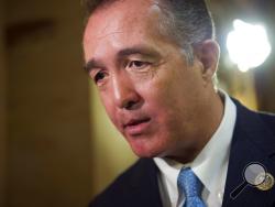 FILE - In this March 24, 2017, file photo, Rep. Trent Franks, R-Ariz. speaks with a reporter on Capitol Hill in Washington. Franks says he is resigning Jan. 31 amid a House Ethics Committee investigation of possible sexual harassment. Franks says in a statement that he never physically intimidated, coerced or attempted to have any sexual contact with any member of his congressional staff. Instead, he says, the dispute resulted from a discussion of surrogacy. Franks and his wife have 3-year-old twins who wer