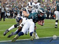  Philadelphia Eagles quarterback Carson Wentz gets tackled during the second half of an NFL football game against the Los Angeles Rams Sunday in Los Angeles. Wentz left the game shortly after the play and did not return. (AP Photo/Mark J. Terrill)